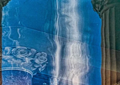Abstract reflection featuring blue tones, marble textures, and a rose motif, creating an artistic interplay of light and shadow